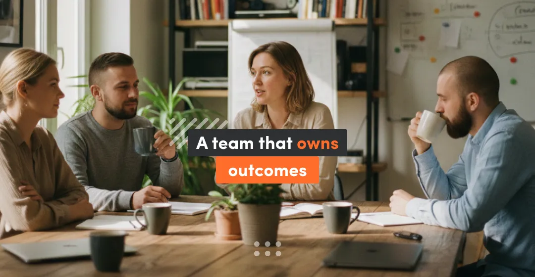 Photo of four people in a meeting around a table with coffee cups and a laptop, with an overlay text that says “A team that owns outcomes.”