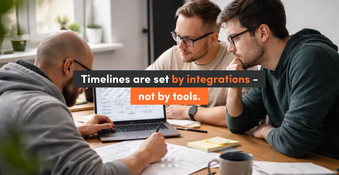 Team reviewing LMS integration requirements on a laptop, emphasizing that LMS implementation timelines are driven by HRIS/SSO integrations and reporting dependencies—not by the platform tool itself.