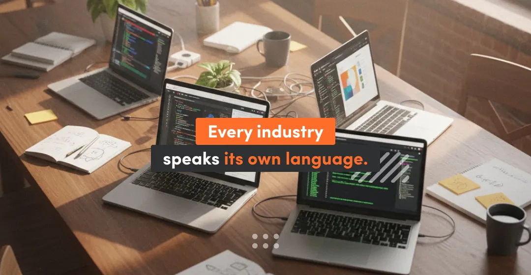 Workspace with multiple laptops running different programming languages, illustrating how industries like web, mobile, data science, and hardware each use distinct coding stacks tailored to their goals and performance needs.