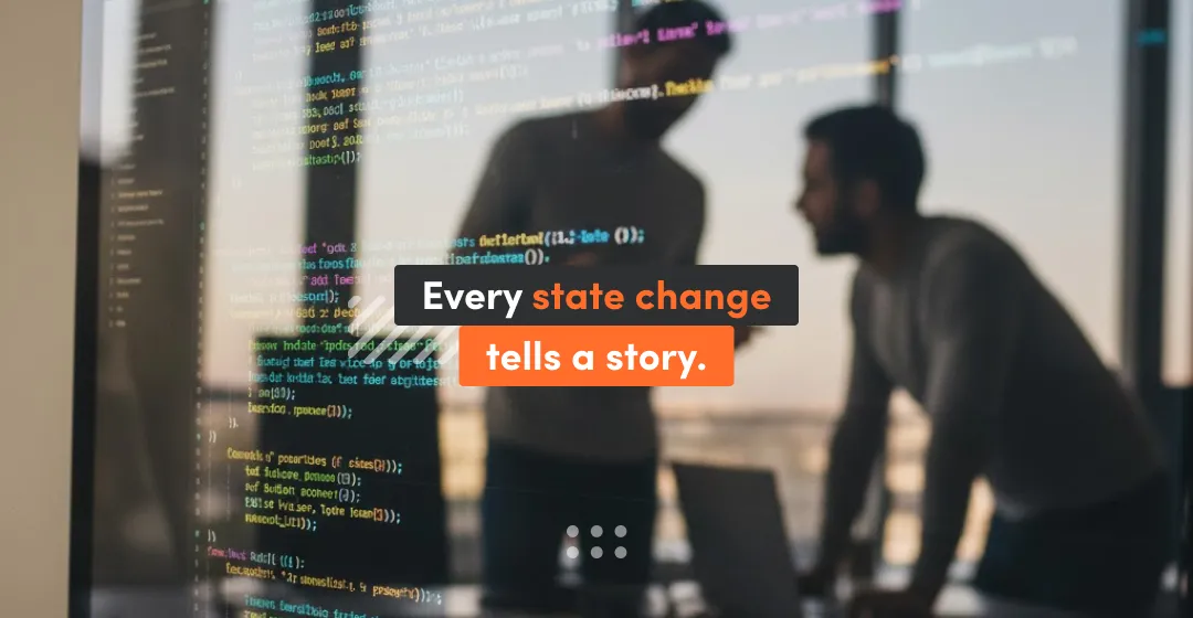 Two developers discussing application logic in front of a screen with JavaScript code, illustrating how every Redux state change is traceable and tells a clear story for debugging and QA.