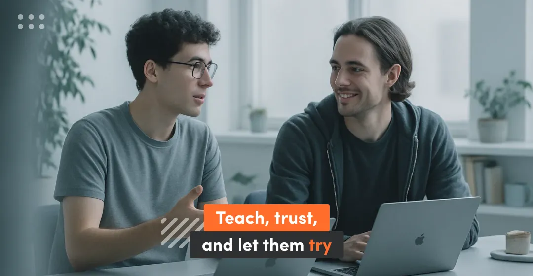 Two men with laptop and inscription "teach, trust and let them try"
