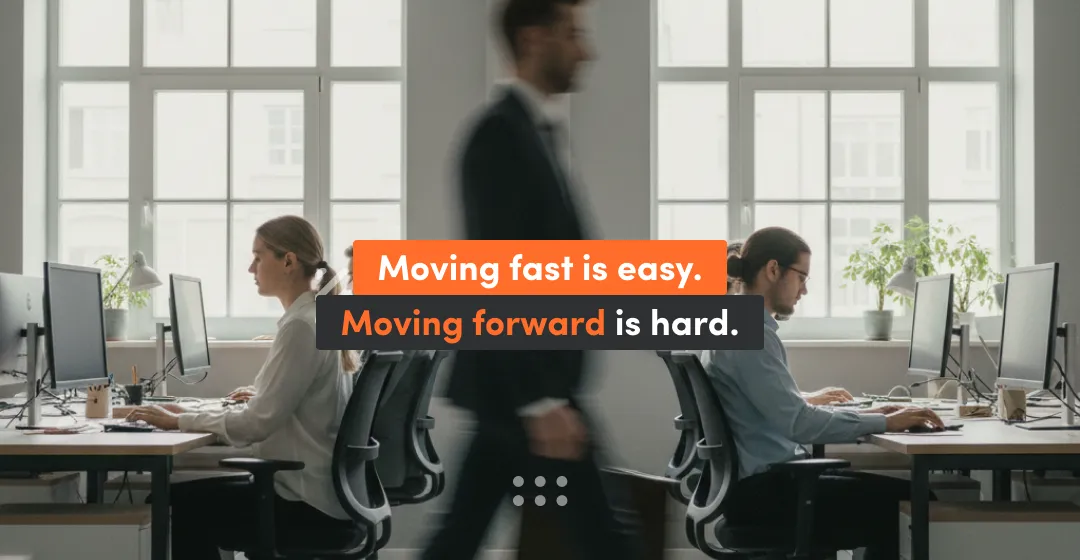 People sitting at the desks and man walking with inscription "moving fast is easy, moving forward is hard"