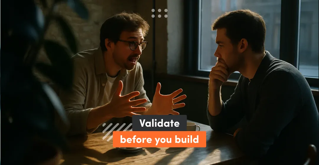 Two  men sitting at the table and talking inscription about validate before you build