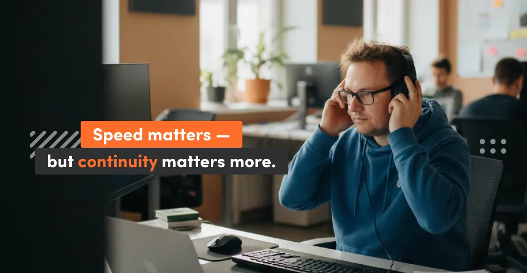 Software developer working at a desk with headphones, highlighting that speed matters but continuity matters more in long-term software development outsourcing and ongoing product delivery.