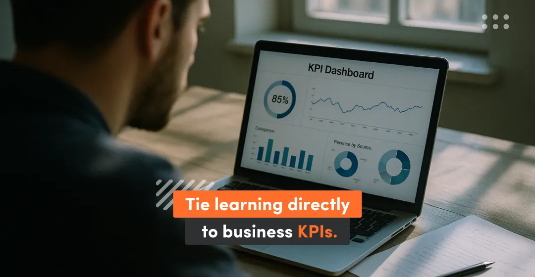 Man with desktop and inscription "tie learning directly to business KPIs"