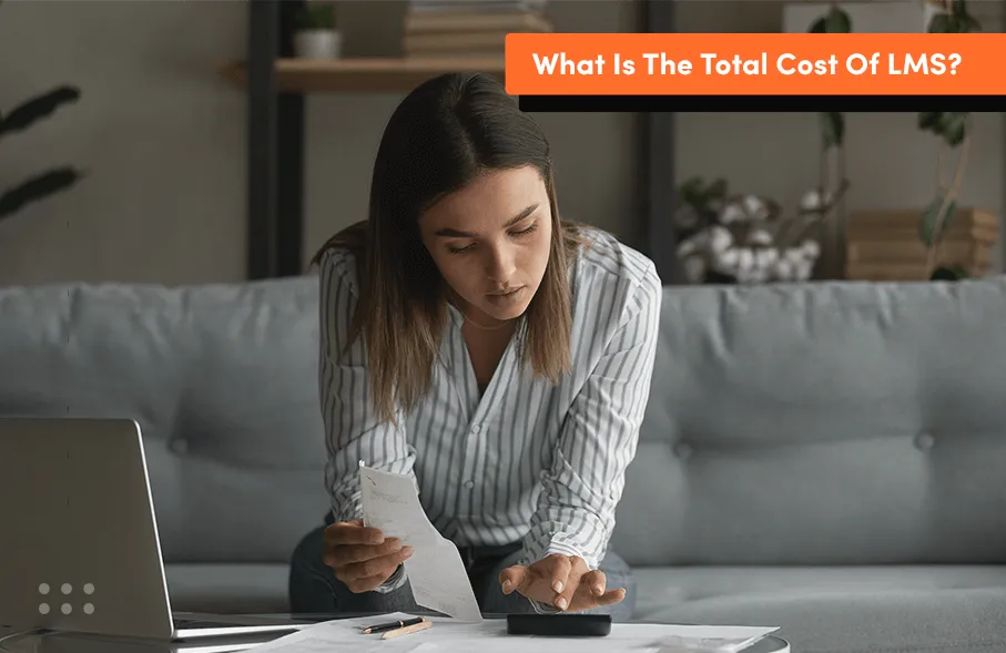 Woman reviewing documents and calculating expenses at a desk, representing how organisations estimate custom LMS development costs based on scope, features, and team size.